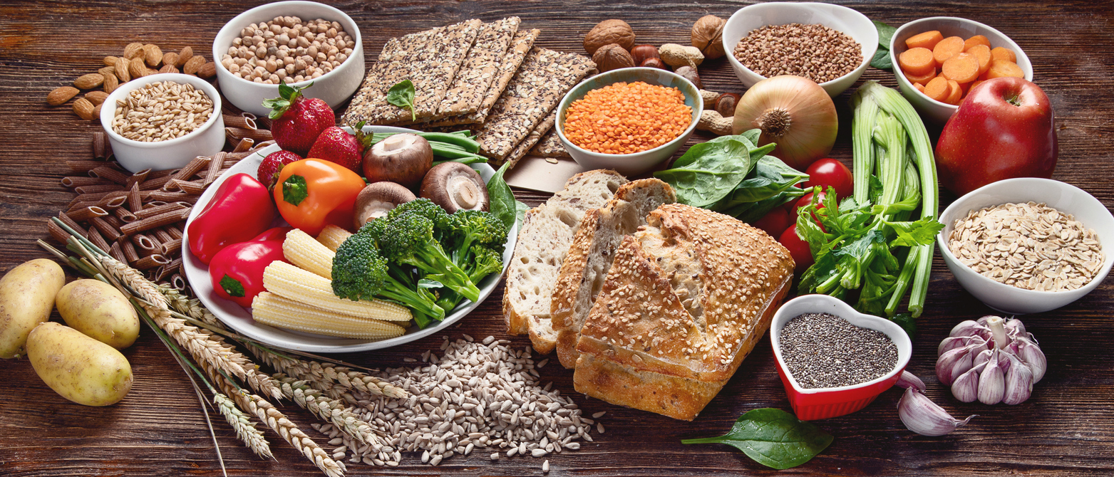 A selection of raw, fibre rich foods on a wooden table