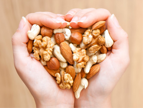 Hands full of mixed nuts